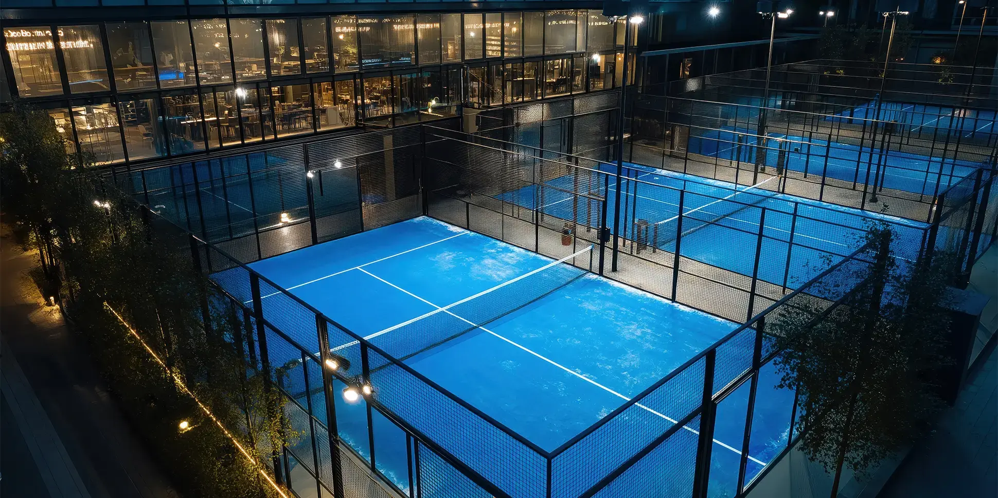 Floodlit padel courts at night